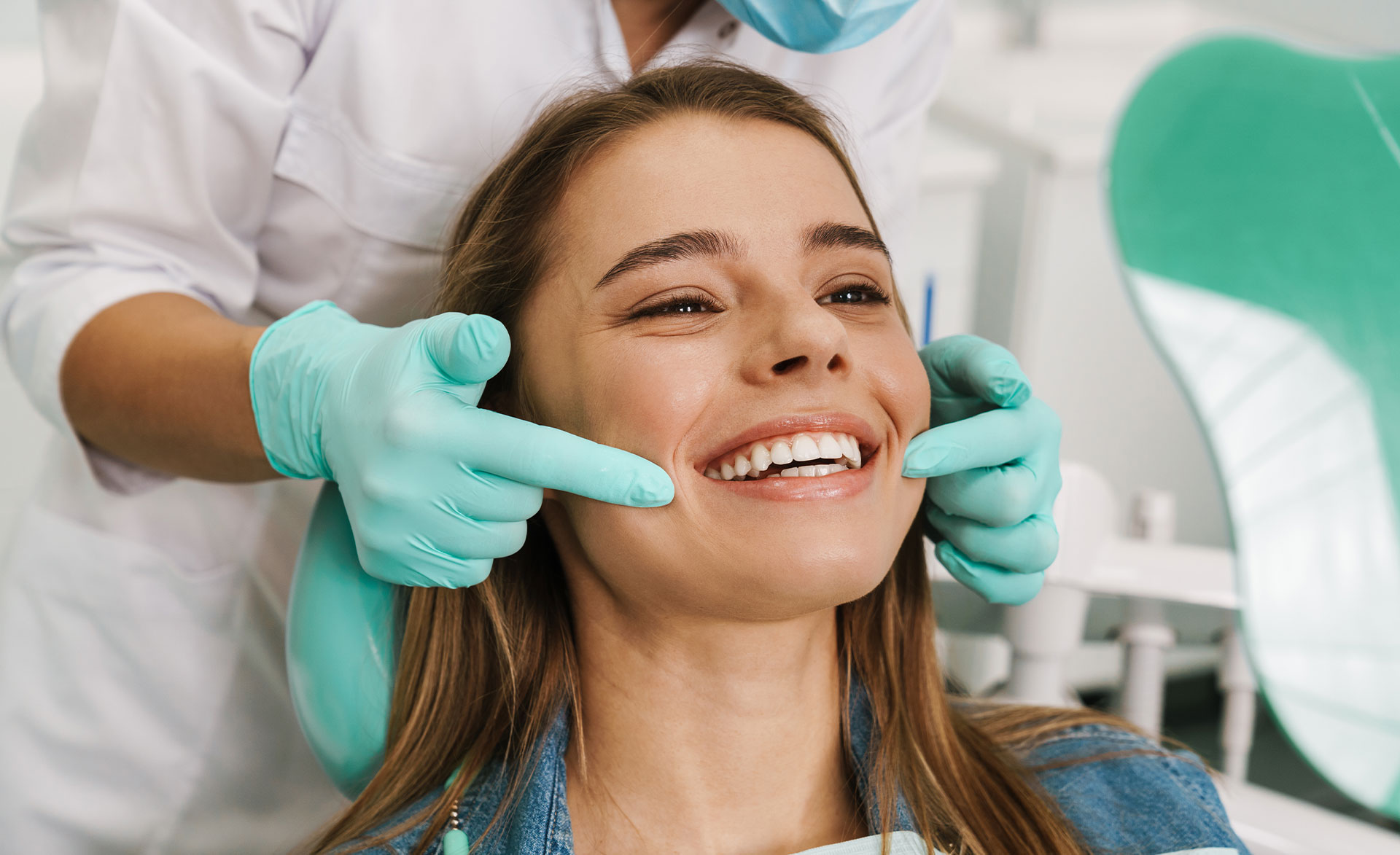 The image shows a modern dental clinic interior with various pieces of equipment, including a dental chair and an X-ray machine.